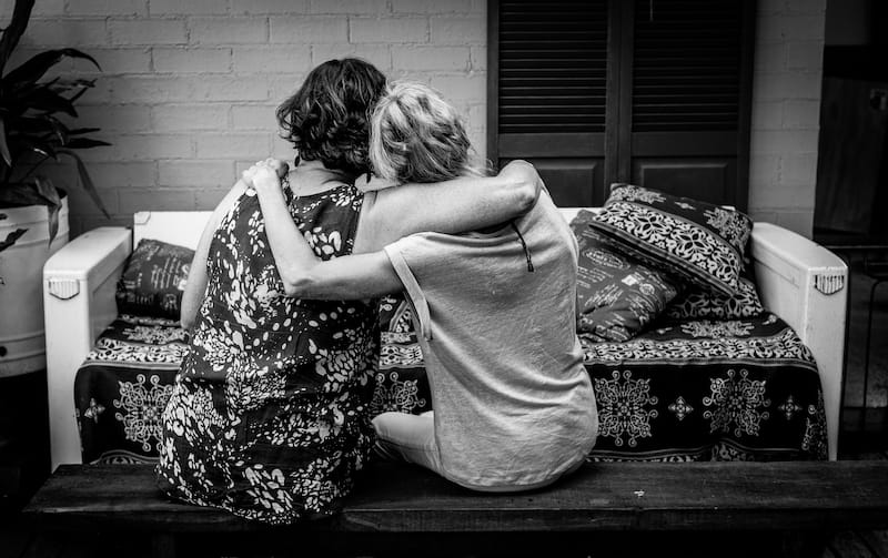 condolence messages women hugging black and white photo