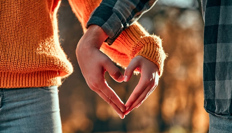 love poems for wife couple making a hand heart in sweater weather